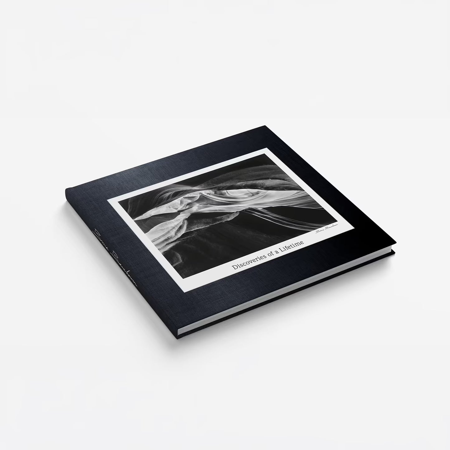 Photobook "Discoveries of a Lifetime" by Bruce Barnbaum. Black cover and white interior displaying a black and white image of a landscape.