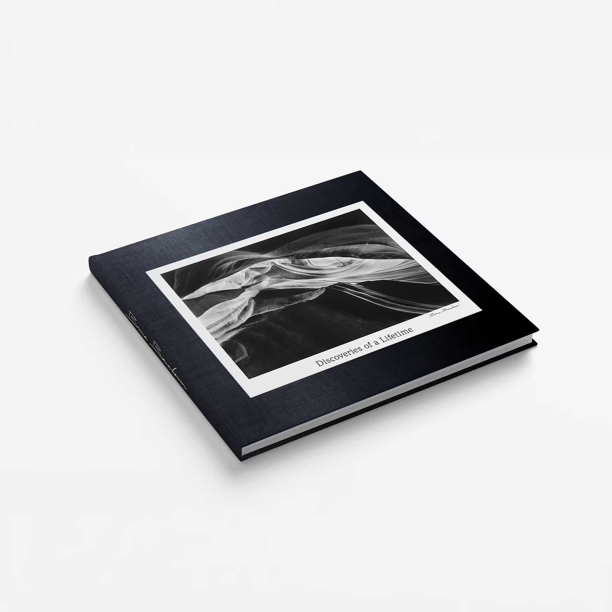 Photobook "Discoveries of a Lifetime" by Bruce Barnbaum. Black cover and white interior displaying a black and white image of a landscape.